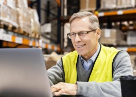 Logistics worker with forklift license and digital tools in warehouse